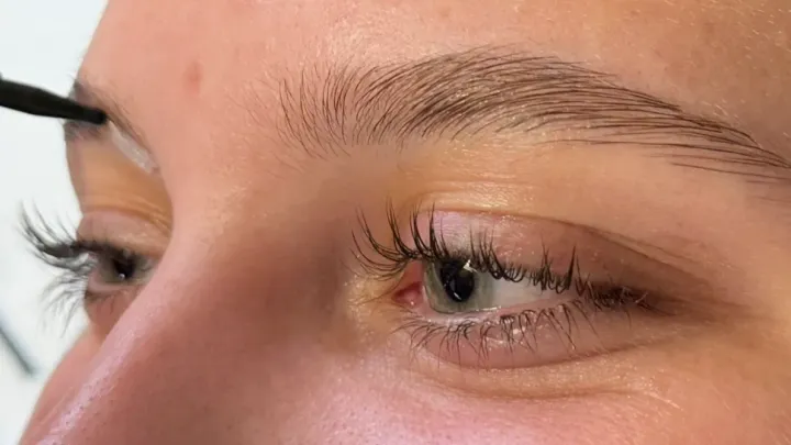 Finished lash lift on natural lashes, lifted from the root and separated, with the brow brushed up