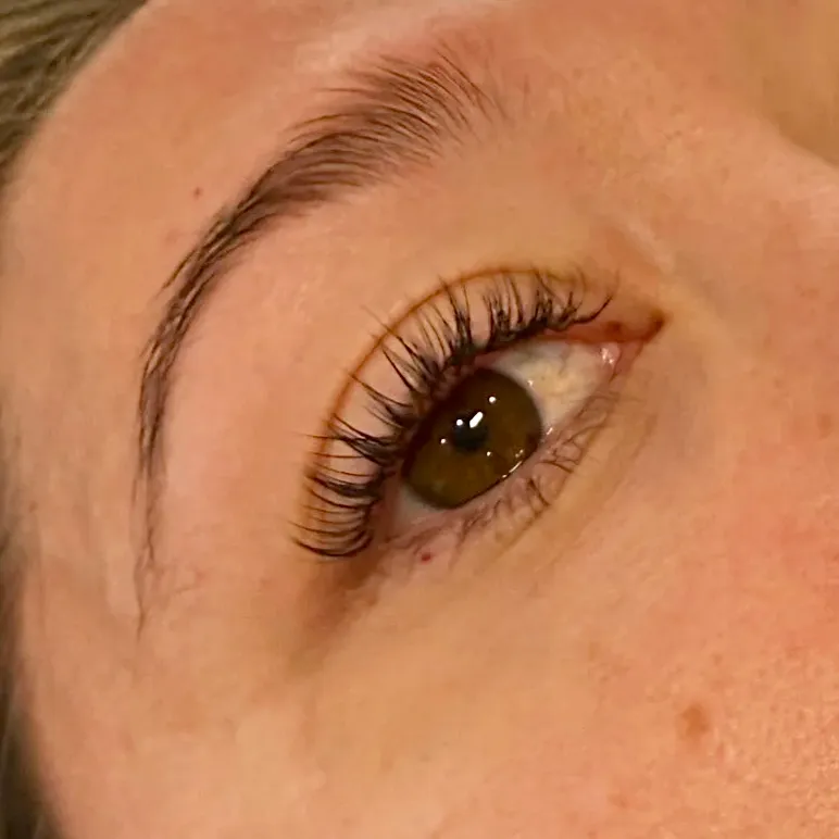 Lash lift on a hazel eye, the natural lashes curled up and away from the eye
