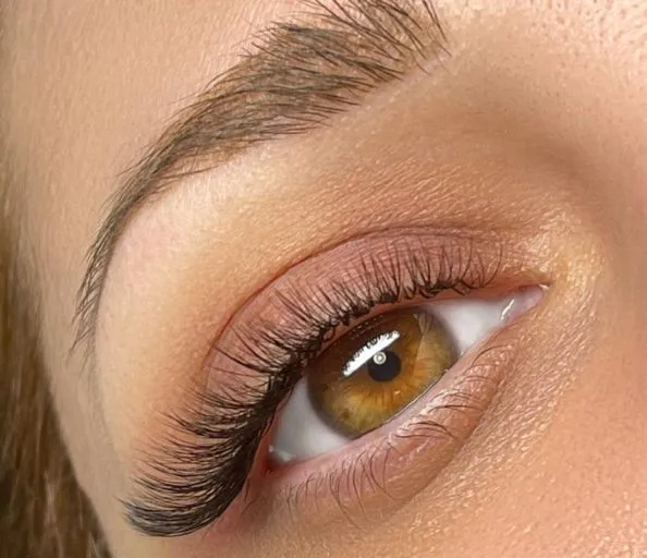 Full volume lash extensions close-up, handmade fans creating a dense, fluffy lash line
